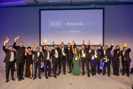 People on stage holding awards and cheering at the DCD Awards