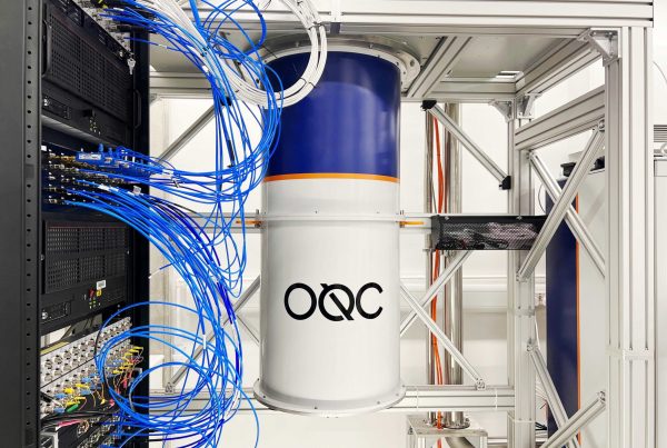 Picture of a quantum computer, with casing on. the logo OQC is on the front cans.